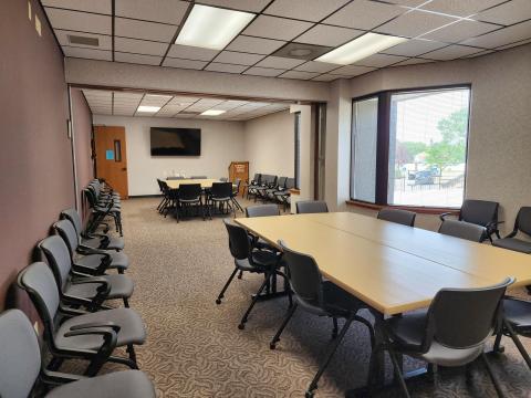 Pioneer Rooms I & II set up with two sets of tables and chairs.